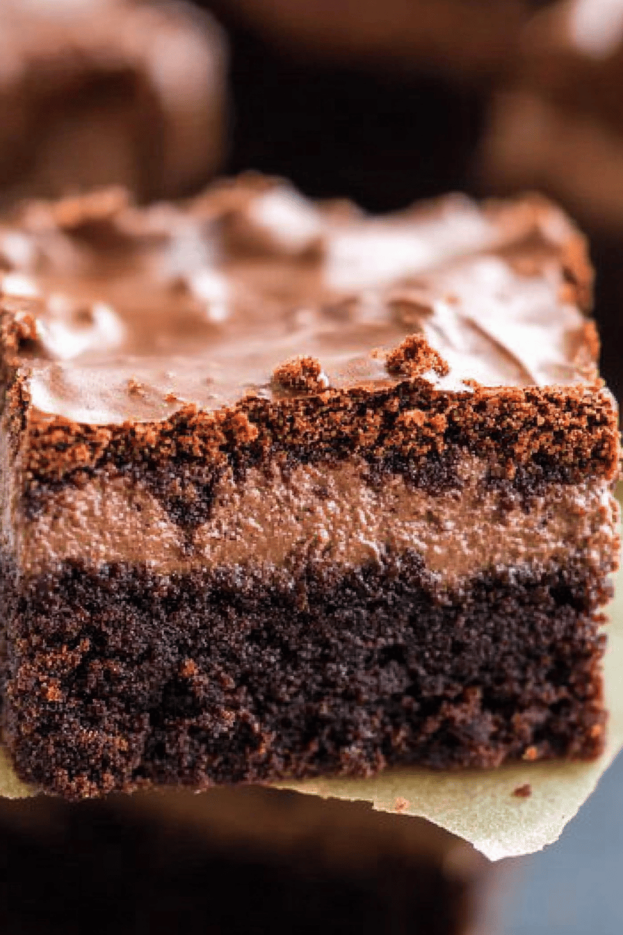 chocolate cheesecake brownies slice on plate showing perfect texture and swirl pattern