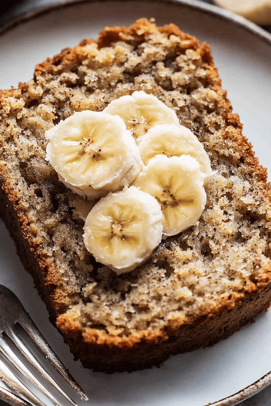 protein banana bread slice on plate showing perfect texture and swirl pattern